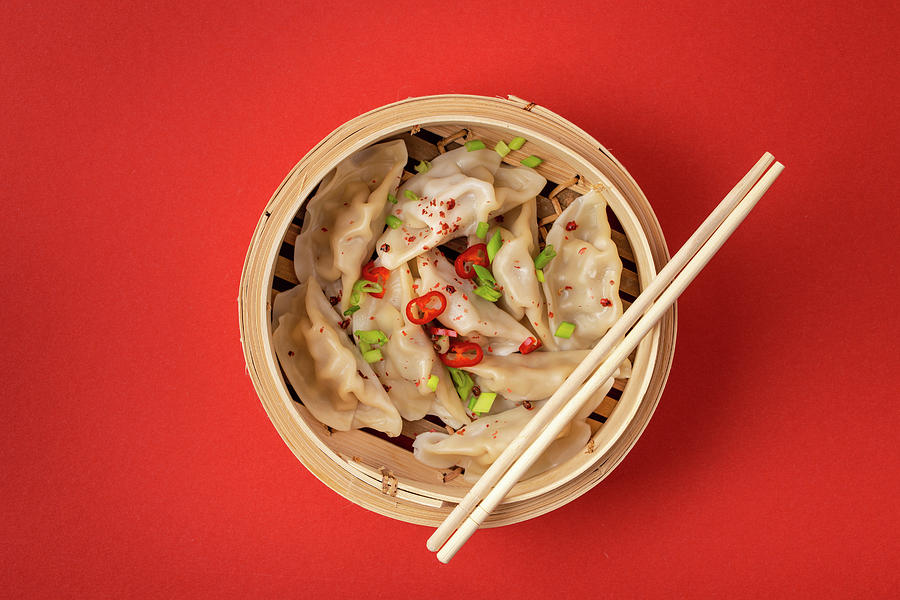 Traditional Chinese Steamed Dumplings In Bamboo Steamer With Wooden Chopsticks Photograph by Olena Yeromenko