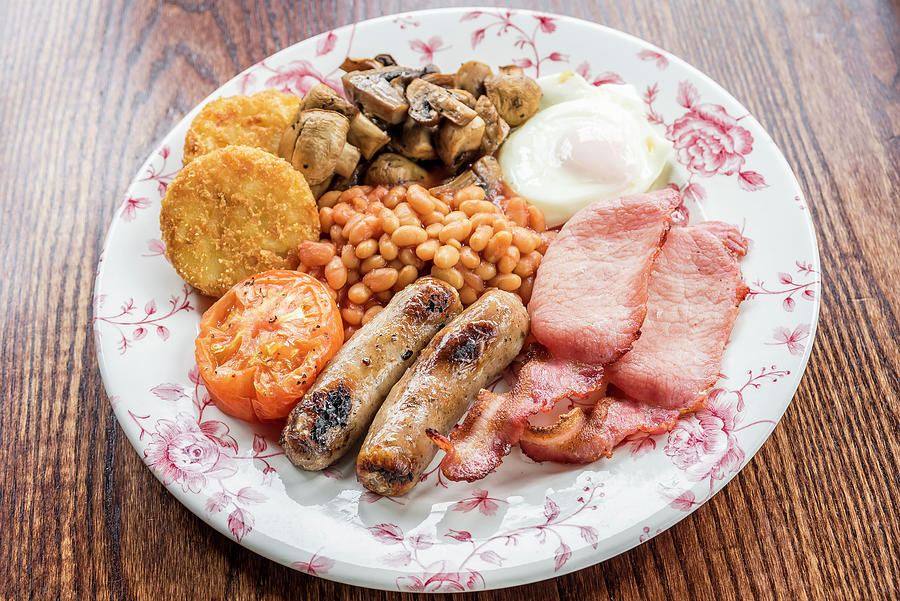 Traditional English Breakfast With Bacon, Sausages, Grilled Tomato And Mushrooms, Baked Beans, Potato Hash Browns Cakes And Egg On A Wooden Table Photograph by Giulia Verdinelli Photography