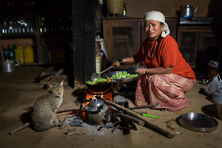 Portrait Photograph - Traditional Nepal Woman Cooking by Dan Mirica
