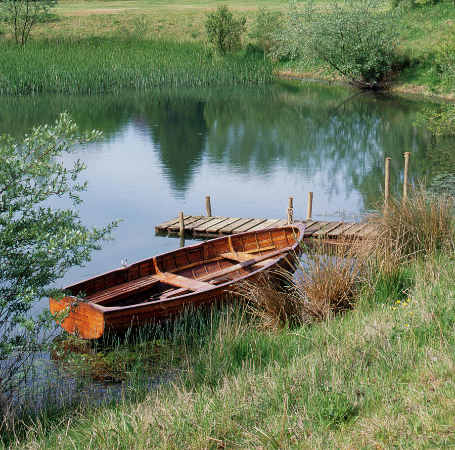 Traditional rowing boat waiting Photograph by Seeables Visual Arts