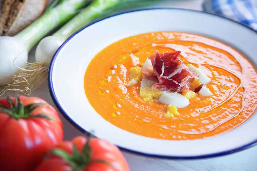 Traditional Spanish Salmorejo - Cold Tomato Soup Served With Boiled Egg, Iberico Ham And Olive Oil Photograph by Albert Gonzalez