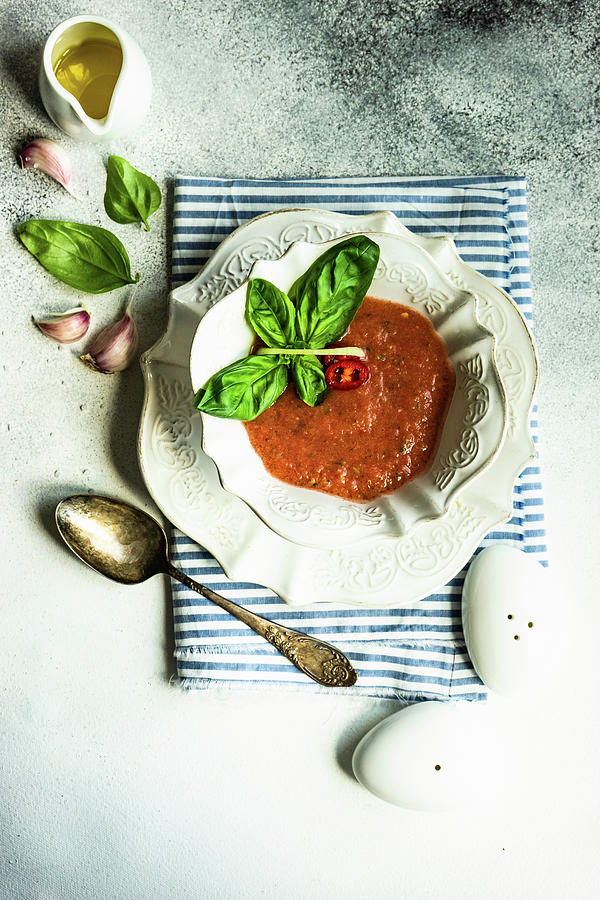 Traditional Spanish Tomato Soup Gazpacho Derved In Ceranic Bowl With Fresh Basil Leaves On Stone Background With Copy Space Photograph by Anna Bogush