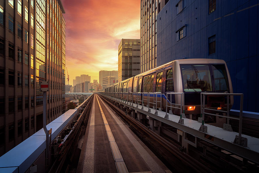Train in city in Tokyo with sunset background Photograph by Anek Suwannaphoom