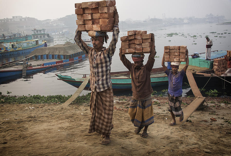 Documentary Photograph - Transporting Bricks At Biruganga Riverbank by Elena Molina