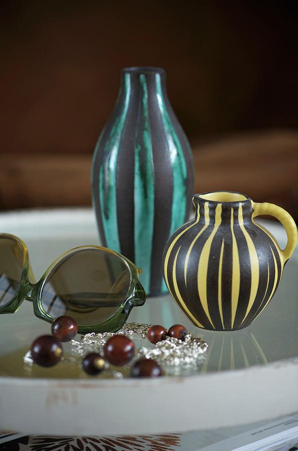 Tray With Two Different Striped Vases And Sunglasses Photograph by Winfried Heinze