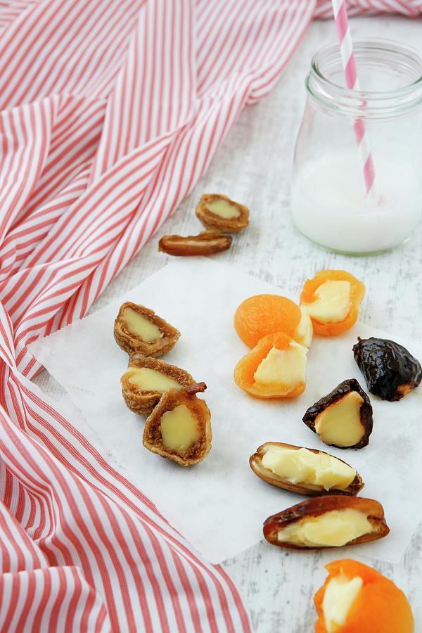 Tried To Date And Apricots Filled With Cream Cheese With A Glass Of Milk And A Straw In The Background Photograph by Sandra Krimshandl-tauscher
