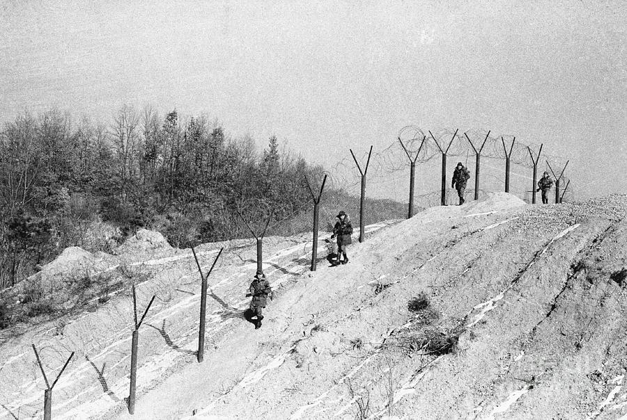 Troops Along Dmz Barrbed Wire Fence Photograph by Bettmann