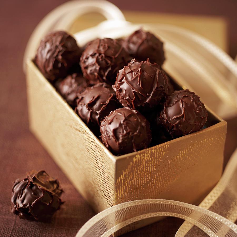 Truffle Pralines In A Golden Box Photograph by Oliver Brachat