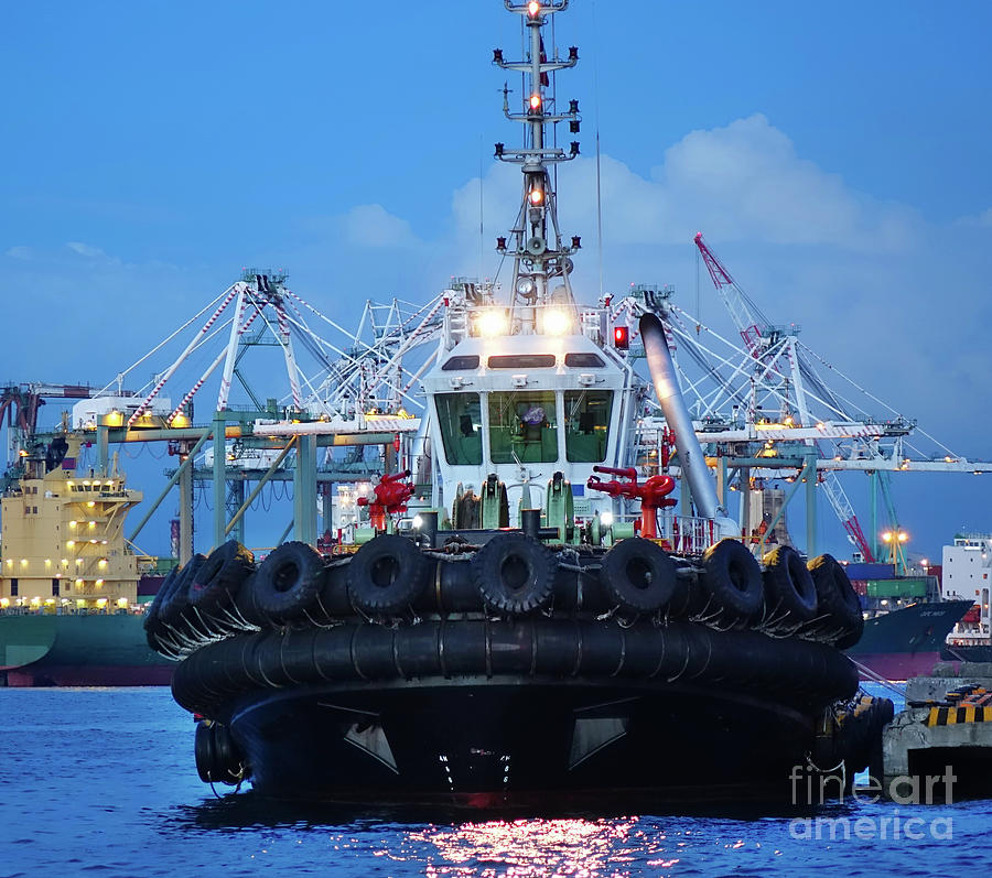 Tugboat with Large Tires at Dusk by Yali Shi Tugboat with Large Tires at Dusk by Yali Shi