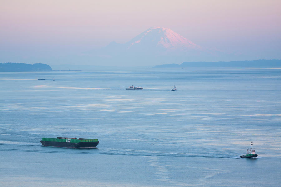 Sunset Photograph - Tugboats Pull Barges In Puget Sound Below Mount Rainier, Washington by Cavan Images