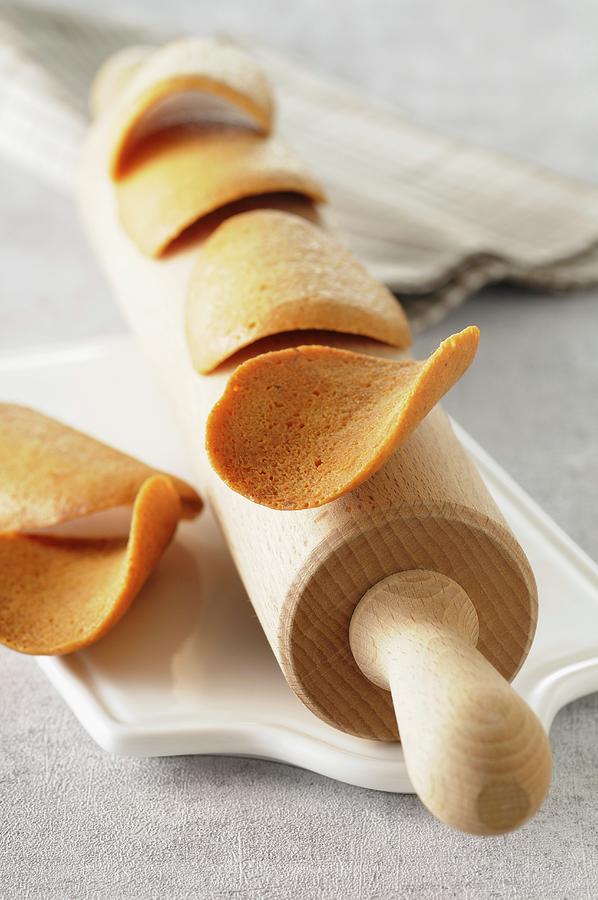 Tuiles wafer Biscuits, France On A Rolling Pin Photograph by Jean-christophe Riou