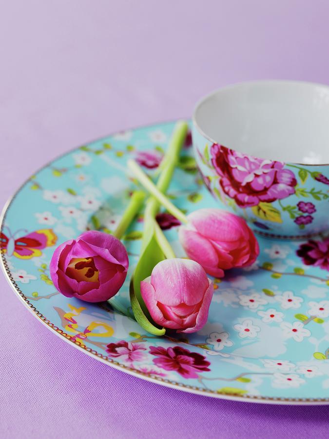 Tulips On A Plate Next To A Matching Bowl With A Floral Pattern Photograph by Michael Paul