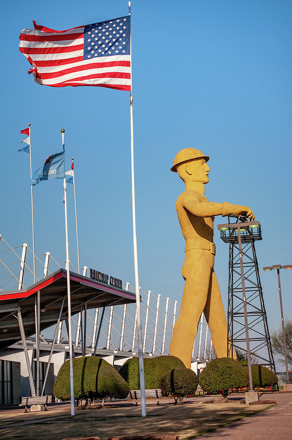 Tulsa Golden Driller Under American Flag Photograph by Gregory Ballos
