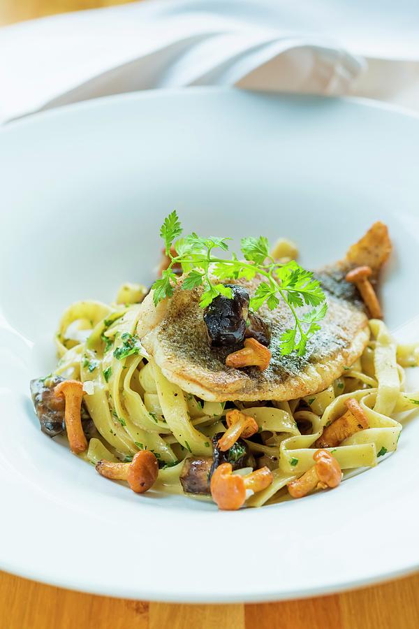 Turbot On A Bed Of Tagliatelle With Mushrooms Photograph by Lukasz Zandecki