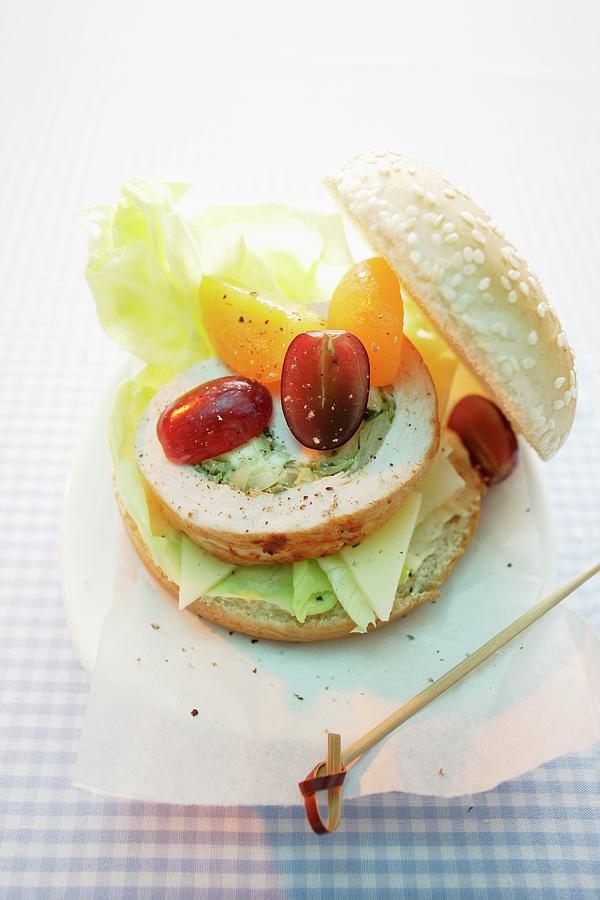Turkey Burger Made With A Slice Of Turkey Roulade, Grapes And Yellow Tomatoes Photograph by Michael Wissing