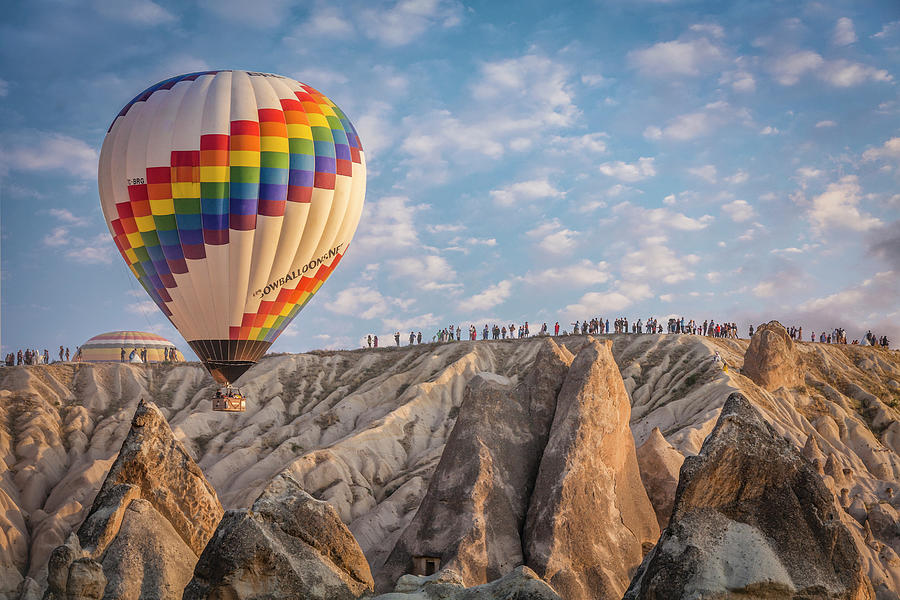 Turkey, Central Anatolia, Goreme, Cappadocia, A Hot Air Balloon Rising Above The Tuff Rock Formations Of Cappadocia Digital Art by Chantal Reed