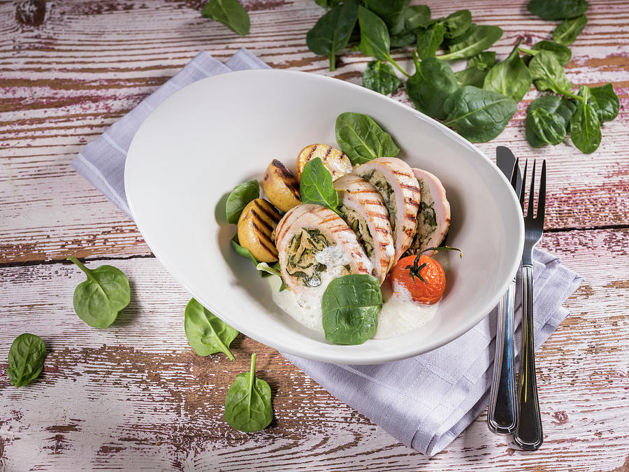 Turkey Roulade With Baby Spinach, Cherry Tomato And Grilled Potatoes Photograph by Niklas Thiemann