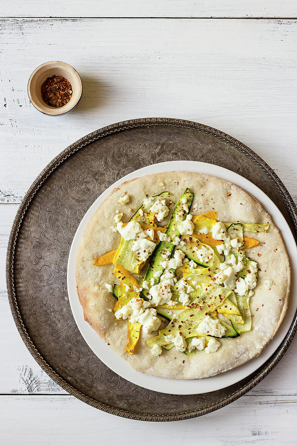 Turkish Pide With Green And Yellow Baby Zucchini, Feta And Chilli Flakes Photograph by Zuzanna Ploch