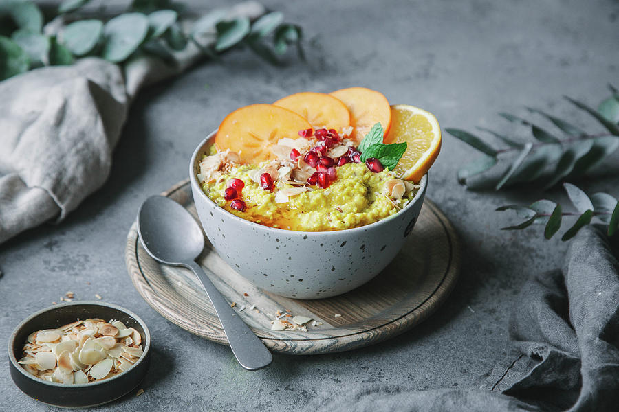 Turmeric And Millet Porridge With Persimmon, Orange And Pomegranate Seeds Photograph by Denise Rene Schuster