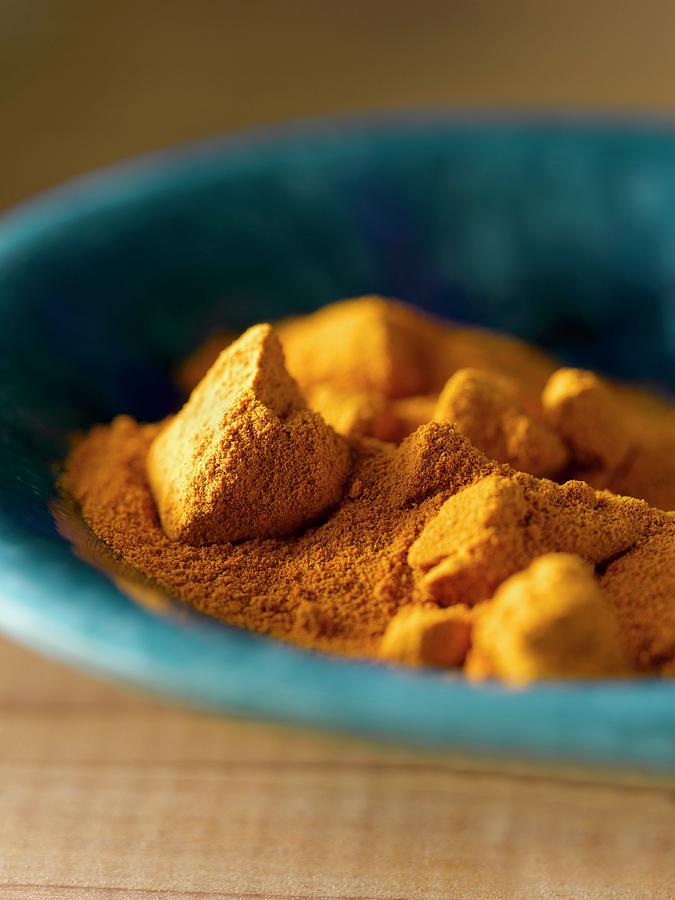 Turmeric Powder And Chunks In A Blue Bowl close-up Photograph by Laurie Proffitt