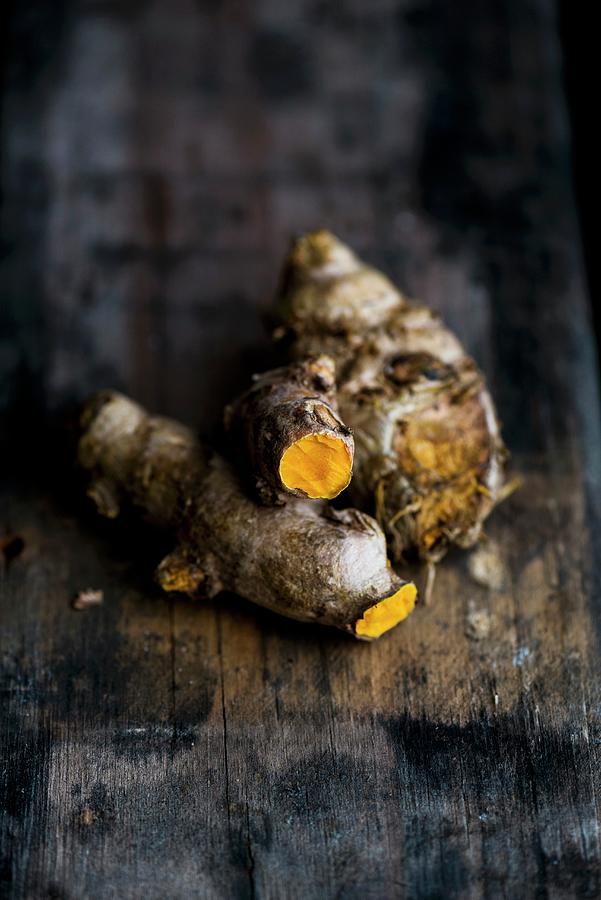 Turmeric Roots On A Wooden Surface Photograph by Hein Van Tonder