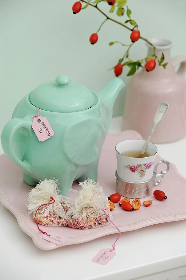 Turquoise Teapot, Vintage Cup, Halved Rose Hips And Fabric Teabags On Pink Serving Tray Photograph by Studio27neun