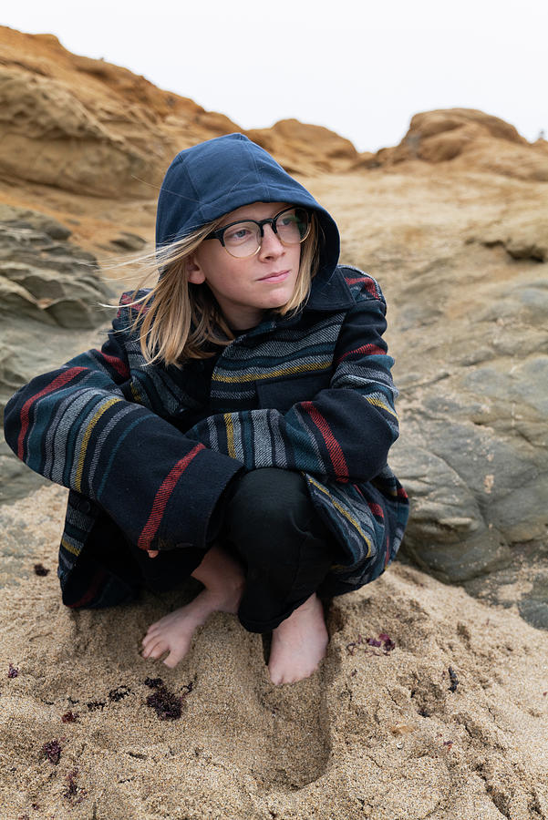 Tween Crouching On Beach In Sand Looking Off Camera Photograph By Cavan