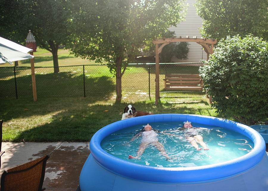 Tween Girls Back Floating In Swimming Pool In Summer Time Outdoors ...