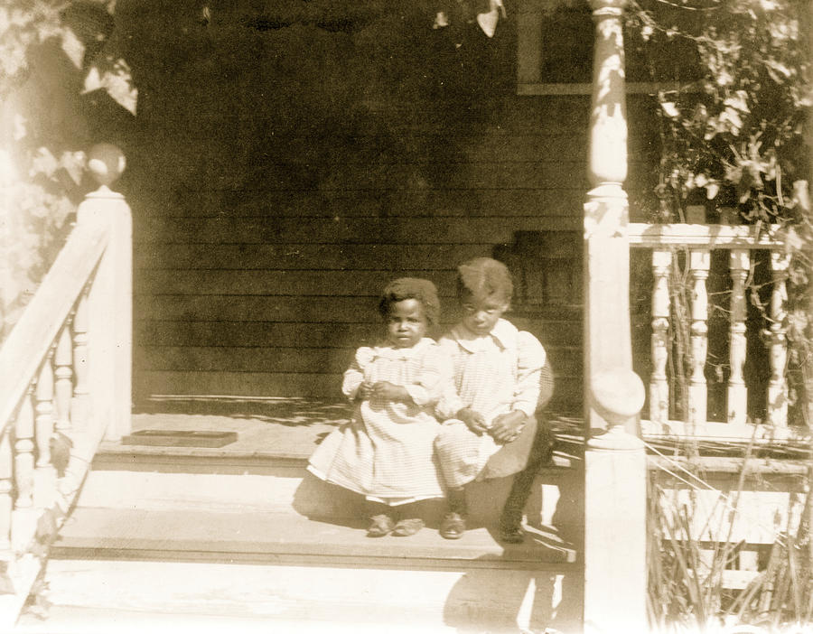 Two African American children sitting on steps to porch Painting by Unknown