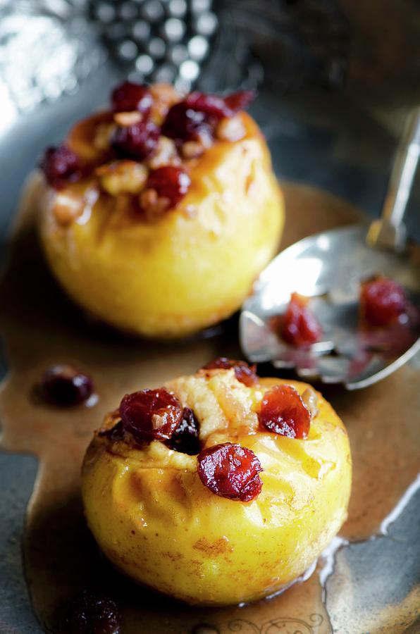 Two Baked Apples With Cranberries On A Pewter Dish With A Silver Spoon Photograph by Jamie Watson