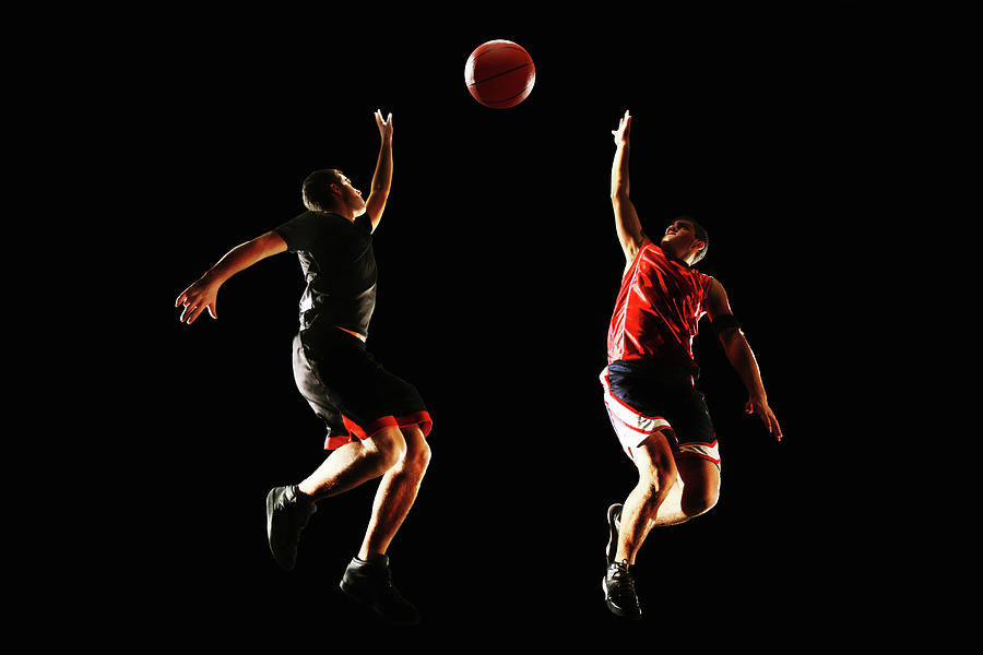 Two Basketball Players Jumping To The Photograph by Stanislaw Pytel