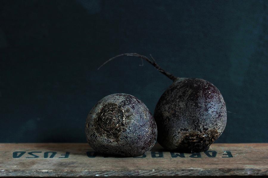 Two Beetroots On A Wooden Crate Against A Dark Background Photograph by Vivi Dangelo