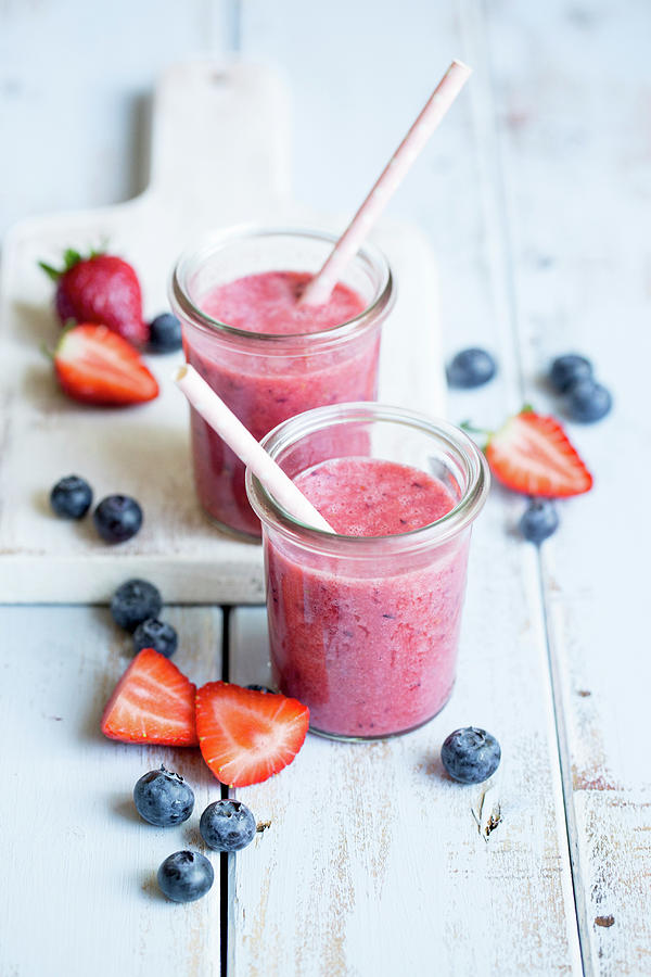 Two Berry Smoothies In Glasses Photograph by Claudia Timmann