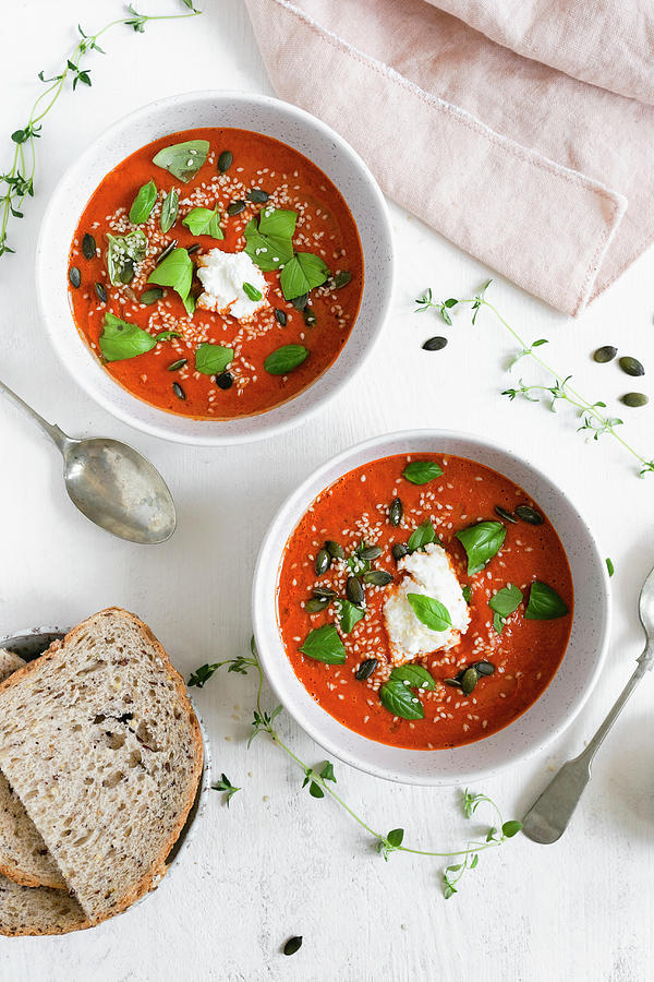 Two Bowls Of Roasted Tomato Soup Topped With Fresh Basil And Ricotta Cheese Photograph by Anna Wierzbinska