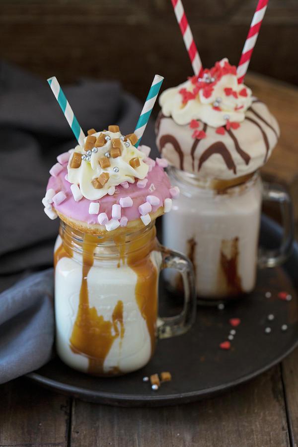 Two Caramel Freakshakes Decorated With Doughnuts Photograph by Nicole Godt