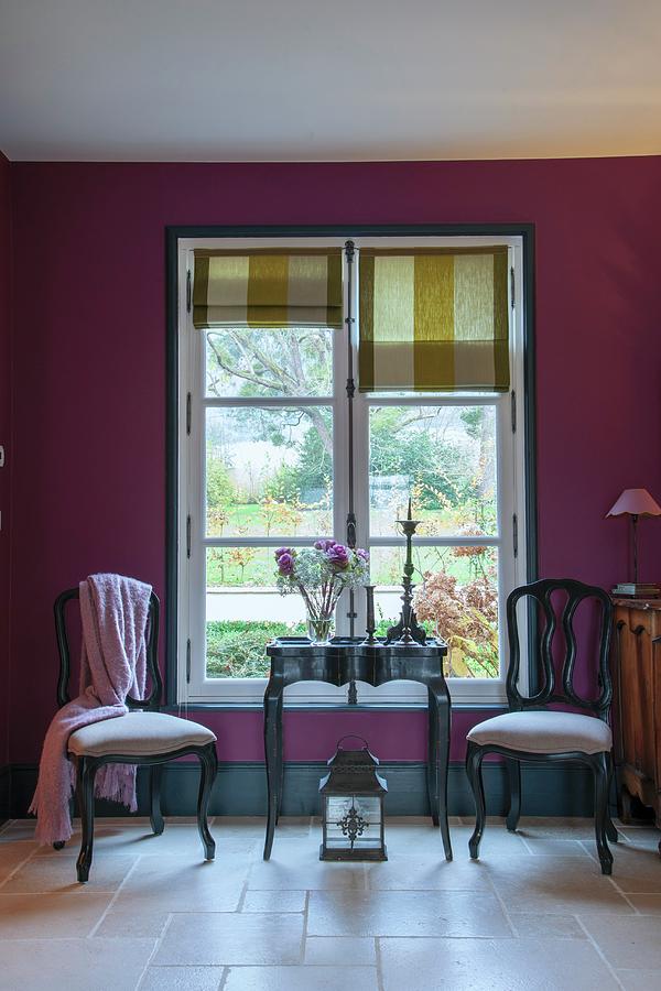 Two Chairs And Table In Front Of Window With Roman Blinds In Purple Wall Photograph by Christophe Madamour