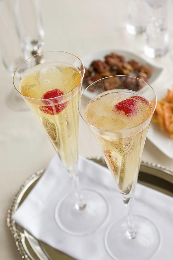 Two Champagne Glasses With Raspberries Photograph by Jim Scherer
