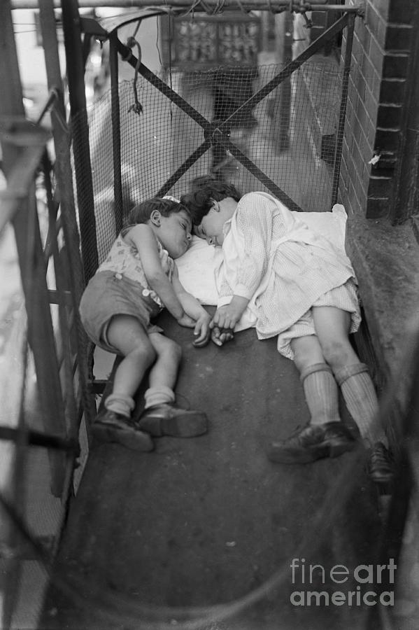 Two Children On The Fire Escape Napping Photograph by Bettmann