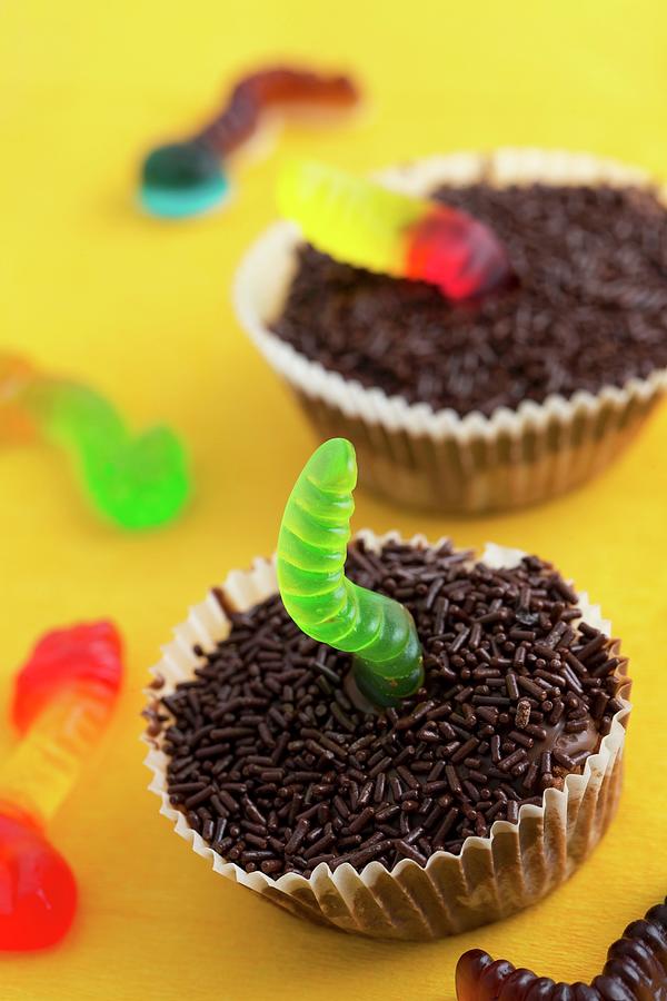 Two Chocolate Cupcakes Decorated With Jelly Worms Photograph by Lydie Besancon