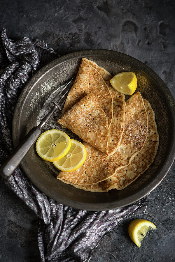 Two Crepes With Lemon Slices On An Antique Plate Photograph by Stacy Grant