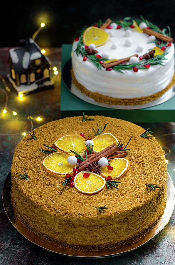 Two Different Christmas Cakes With Oranges And Cinnamon Sticks Photograph by Gorobina