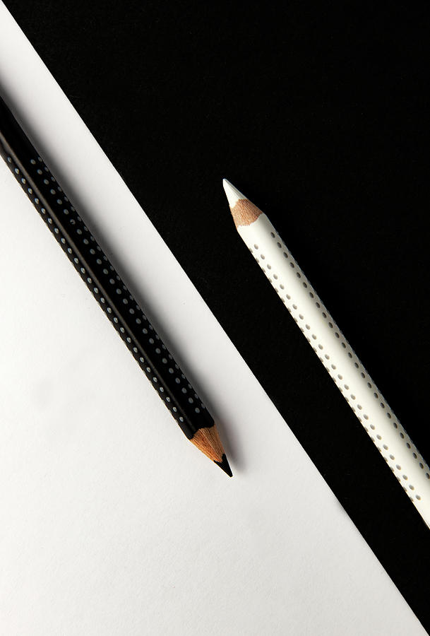 Two drawing pencils on a black and white surface. Photograph by Michalakis Ppalis