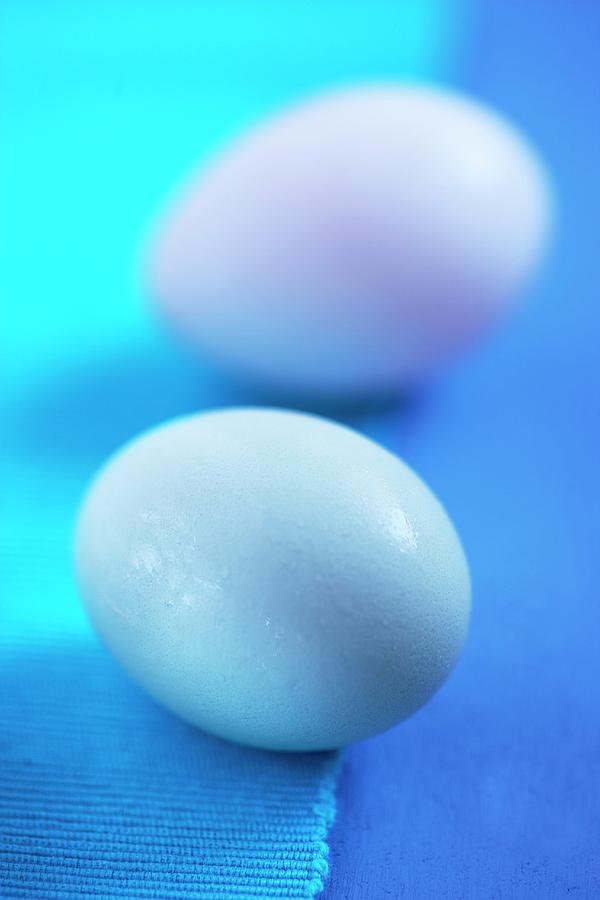 Two Duck Eggs On A Blue Surface Photograph by Tim Pike