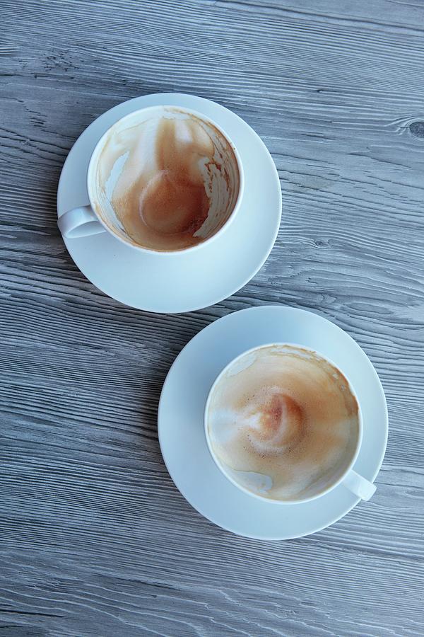 Two Empty Cappuccino Cups Photograph by Peter Garten