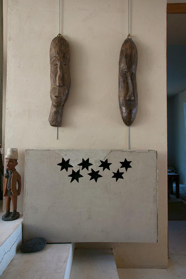 Two Ethnic Wooden Masks On Wall Above Radiator Screen With Star-shaped Cut-outs Photograph by Christophe Madamour