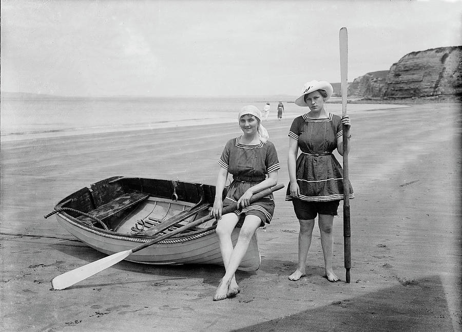 Two Female Bathers, Rowboat On The Beach Photograph by Science Source