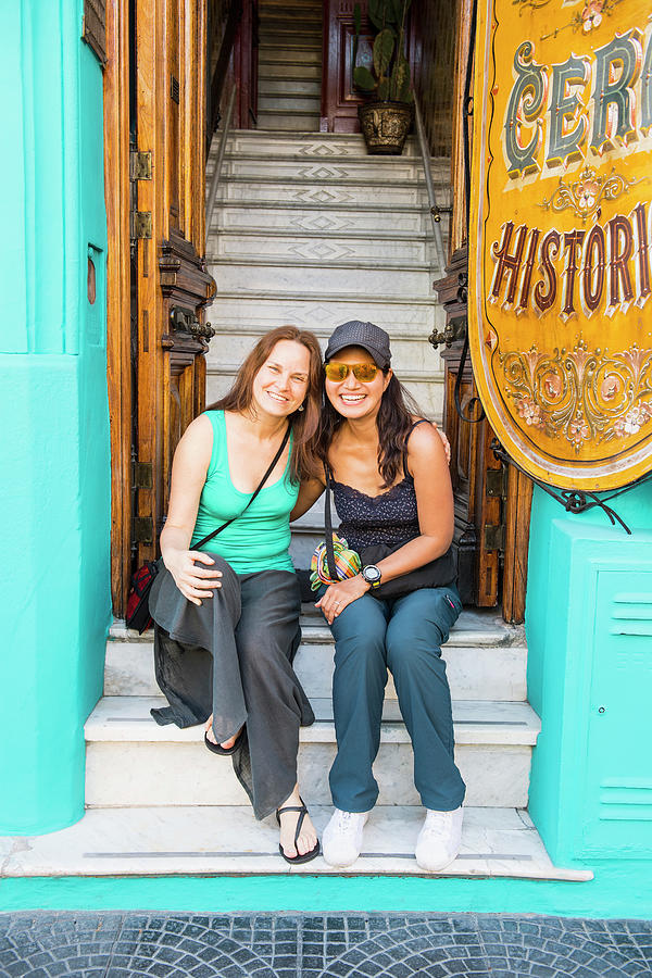 City Photograph - Two Female Friends Sitting At The Entrance Of House In Buenos Aires by Cavan Images