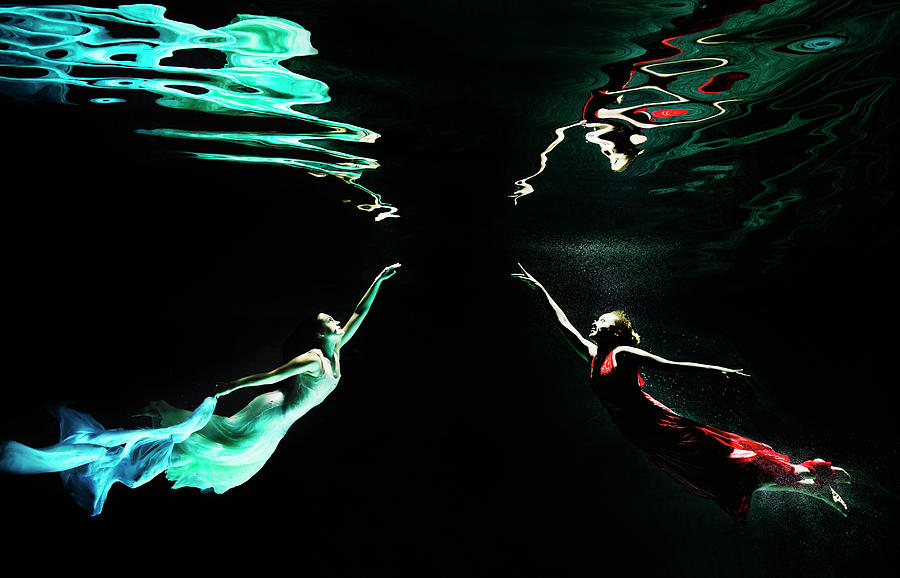 Two Females Under Water In Flowing Photograph by Henrik Sorensen