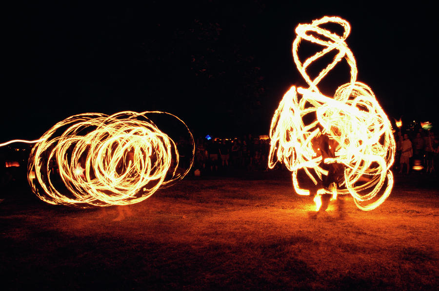 Two Fire-twirlers At Night Photograph by Brian Cassie