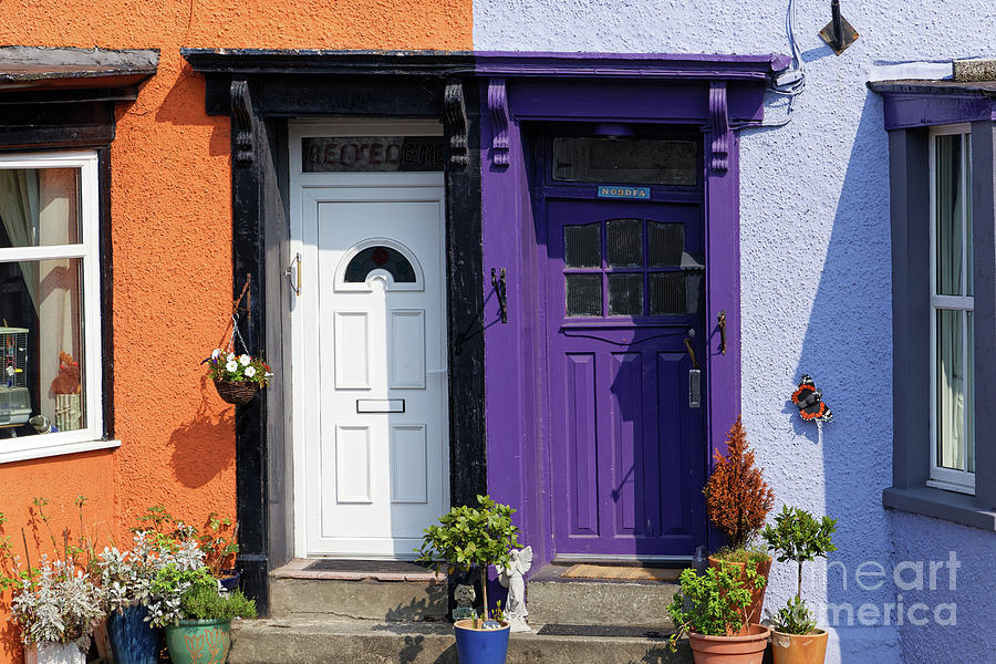 Two flashy attractive apartment house doors side by side purple white orange living free living loud Photograph by Robert C Paulson Jr